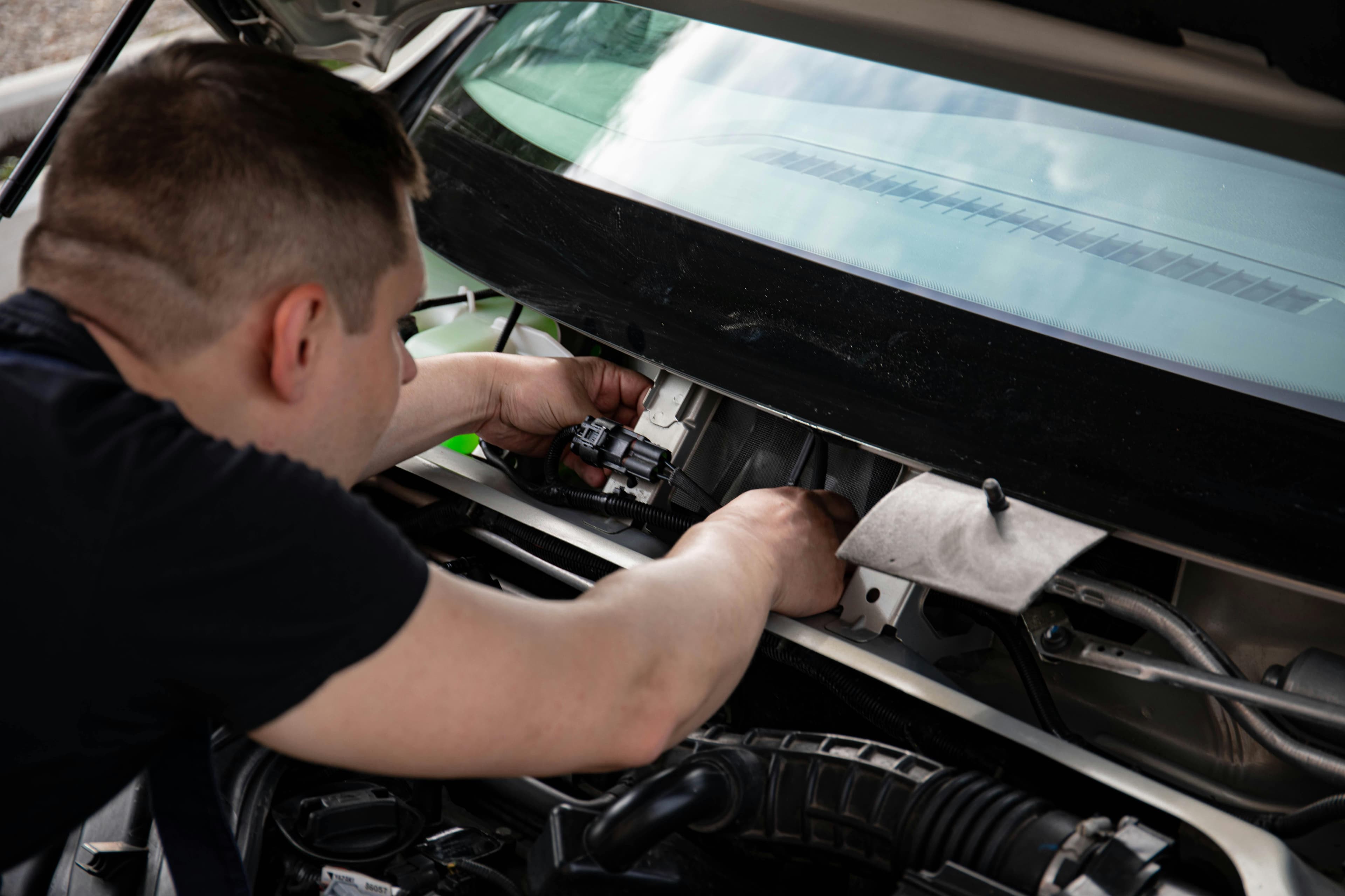 Mechanic servicing a car engine